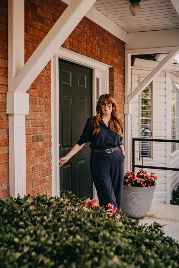 Lisa Giebelhaus holds open the front door of her office, welcoming visitors from the brick porch.