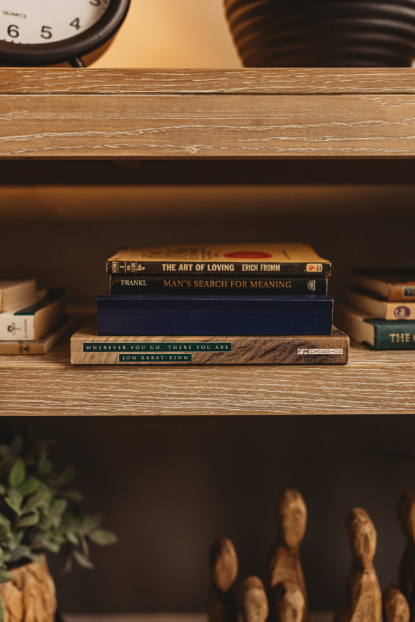 A shelf of books on meaning, love and mindfulness in Lisa Giebelhaus's office.